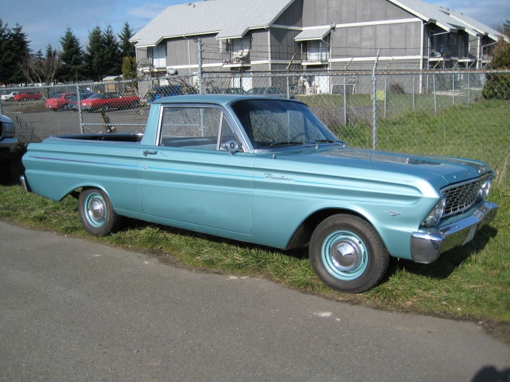 an older pick up truck parked next to a car