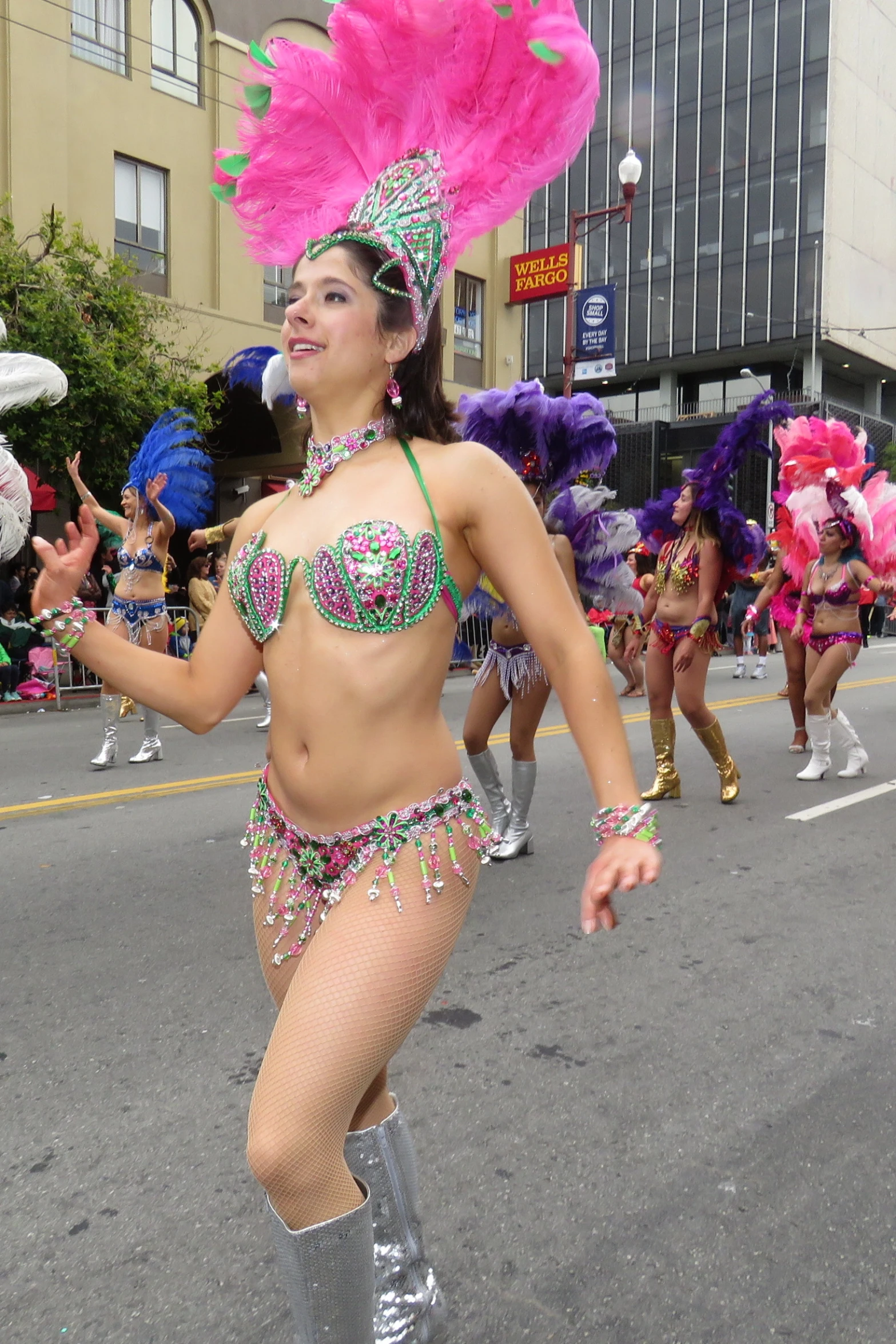 a group of dancers in bikinis and costumes in the street