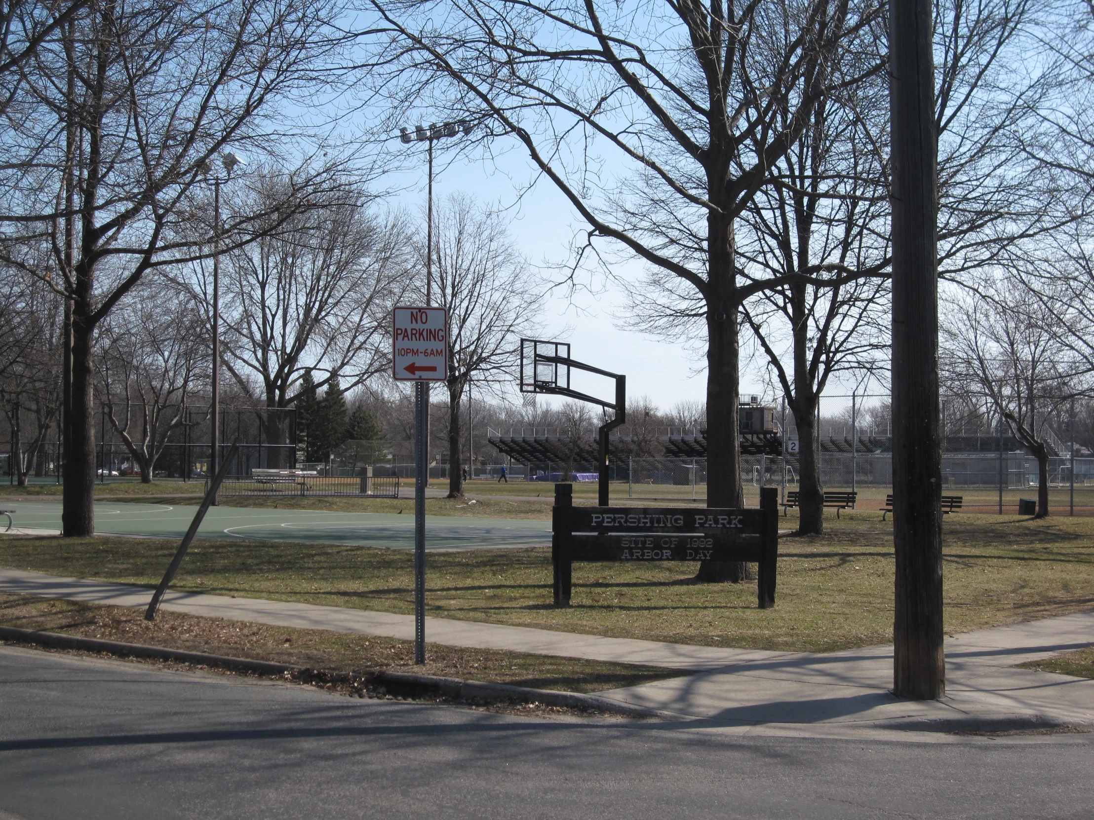 two basketball hoops and an empty basketball court in the park
