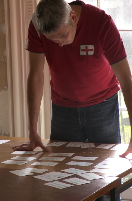 a man is standing next to the table covered in stickers