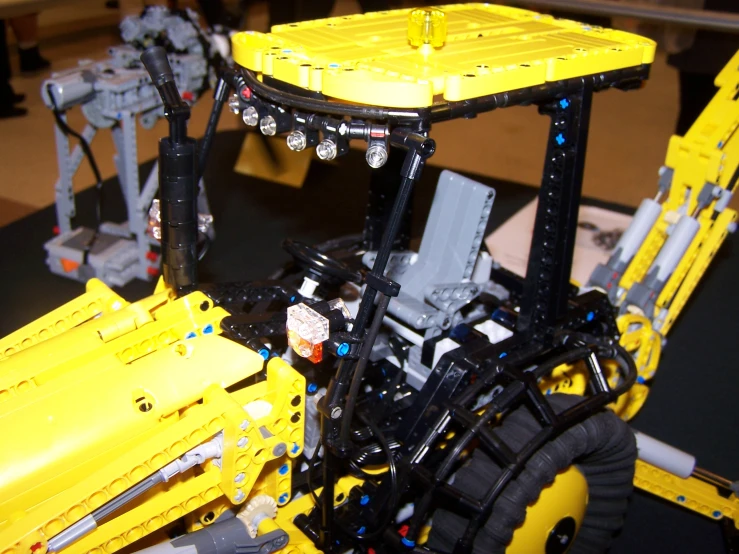 the front end of a tractor with yellow construction parts