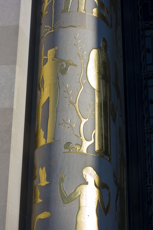 a close up view of the side of a building with gold decoration