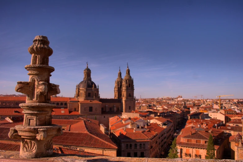 the skyline and spires of a city with brick roofs