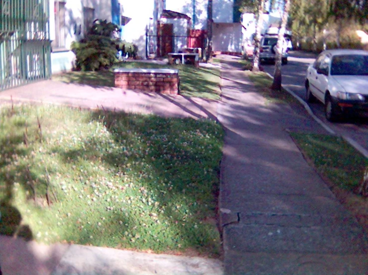 a parking lot and grassy area on a residential street