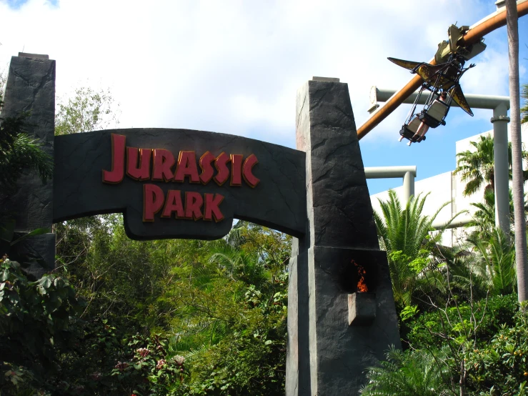 a strange creature with a man flying above its head on the sign