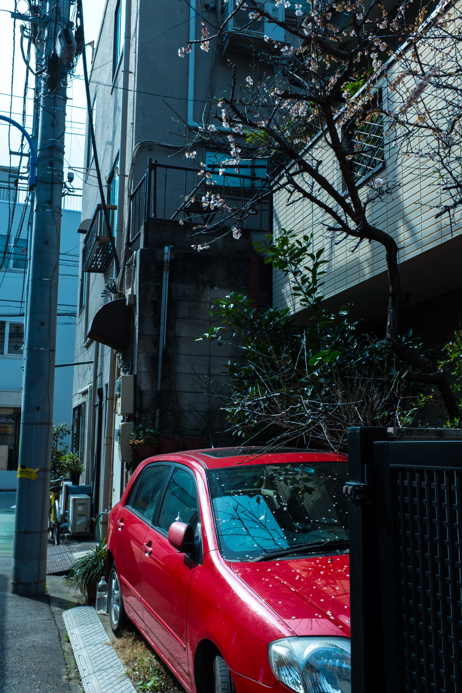 a car parked next to tall buildings in the city