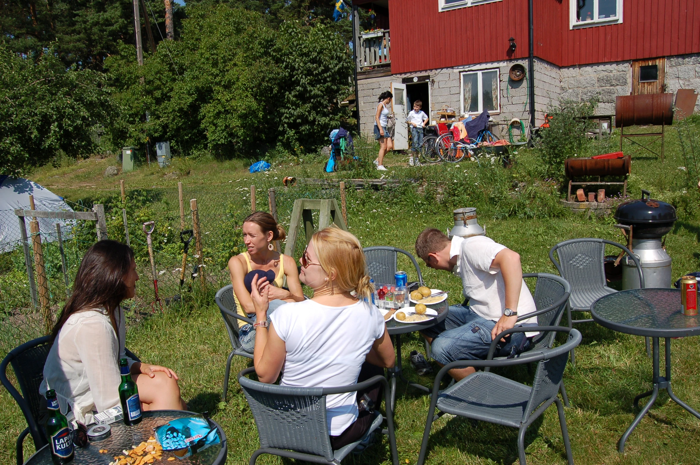 several people are enjoying a meal in the sun