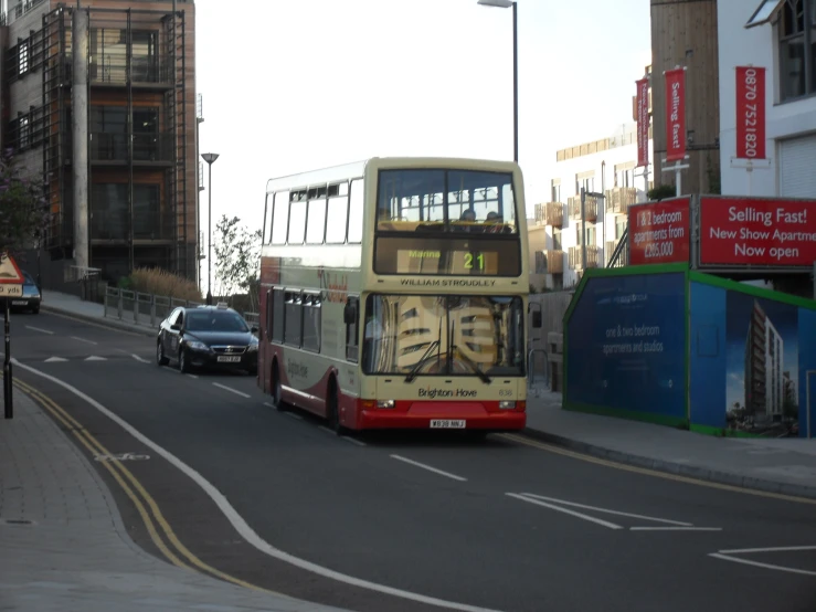 double decker bus on a city street passing a car