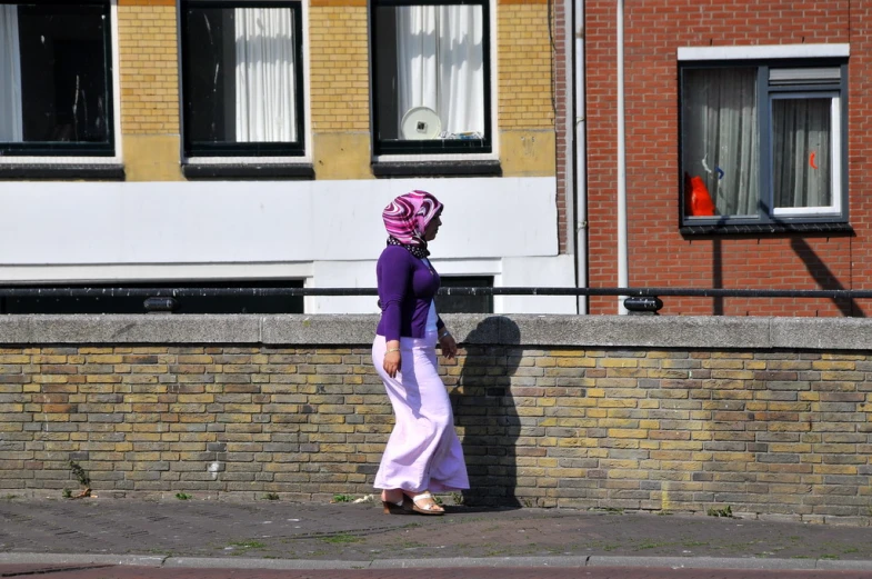a woman in a purple top standing in the street