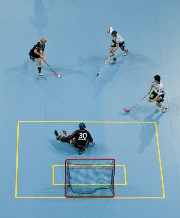 two teams of players playing a game of field hockey