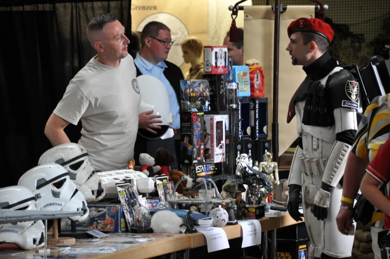 several men in costumes are standing at a table