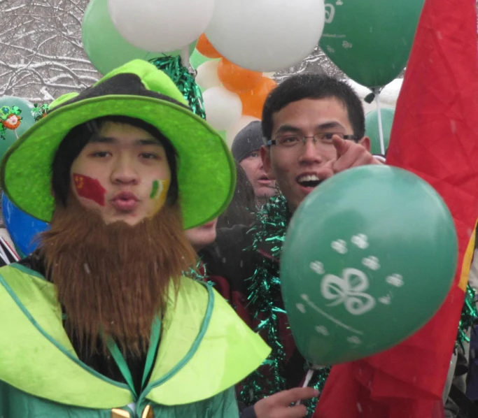 two people wearing costumes with face paint and balloons