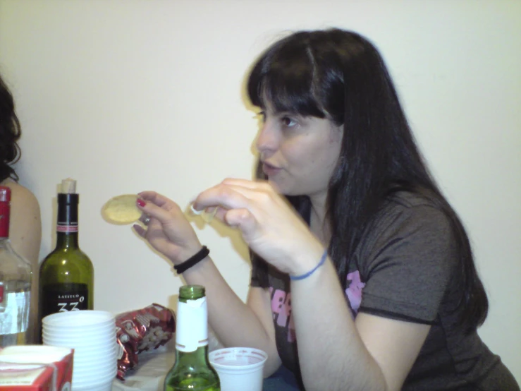 two girls sitting at a table eating food