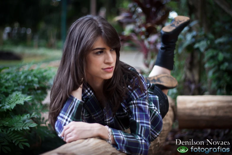 the girl is posing on the log for her po