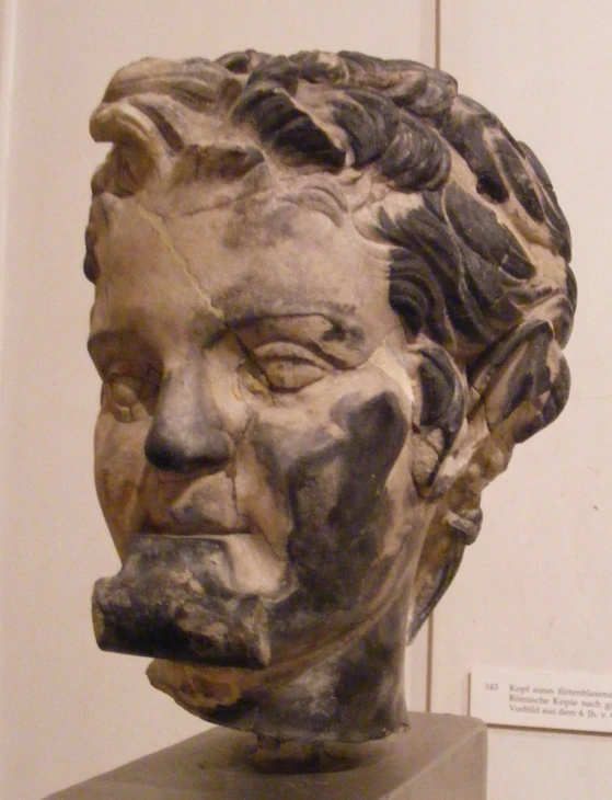 a large bust of a man with his hair pulled up