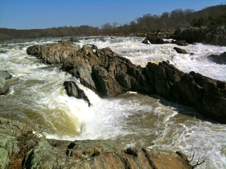 the water is raging up a small rapid