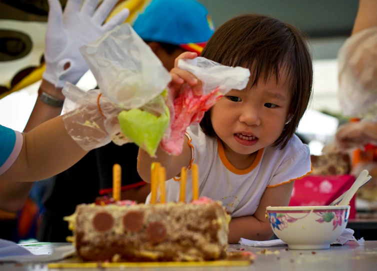 a little girl getting ready to blow out candles on her cake