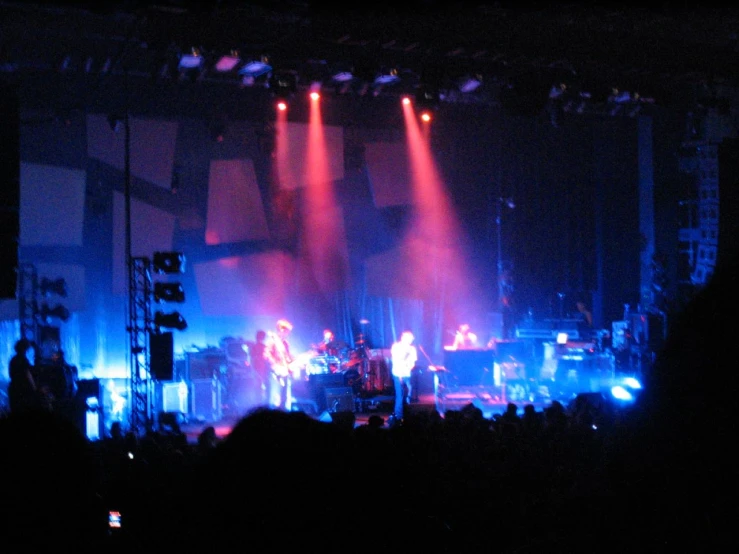 a band performing in the dark at a concert