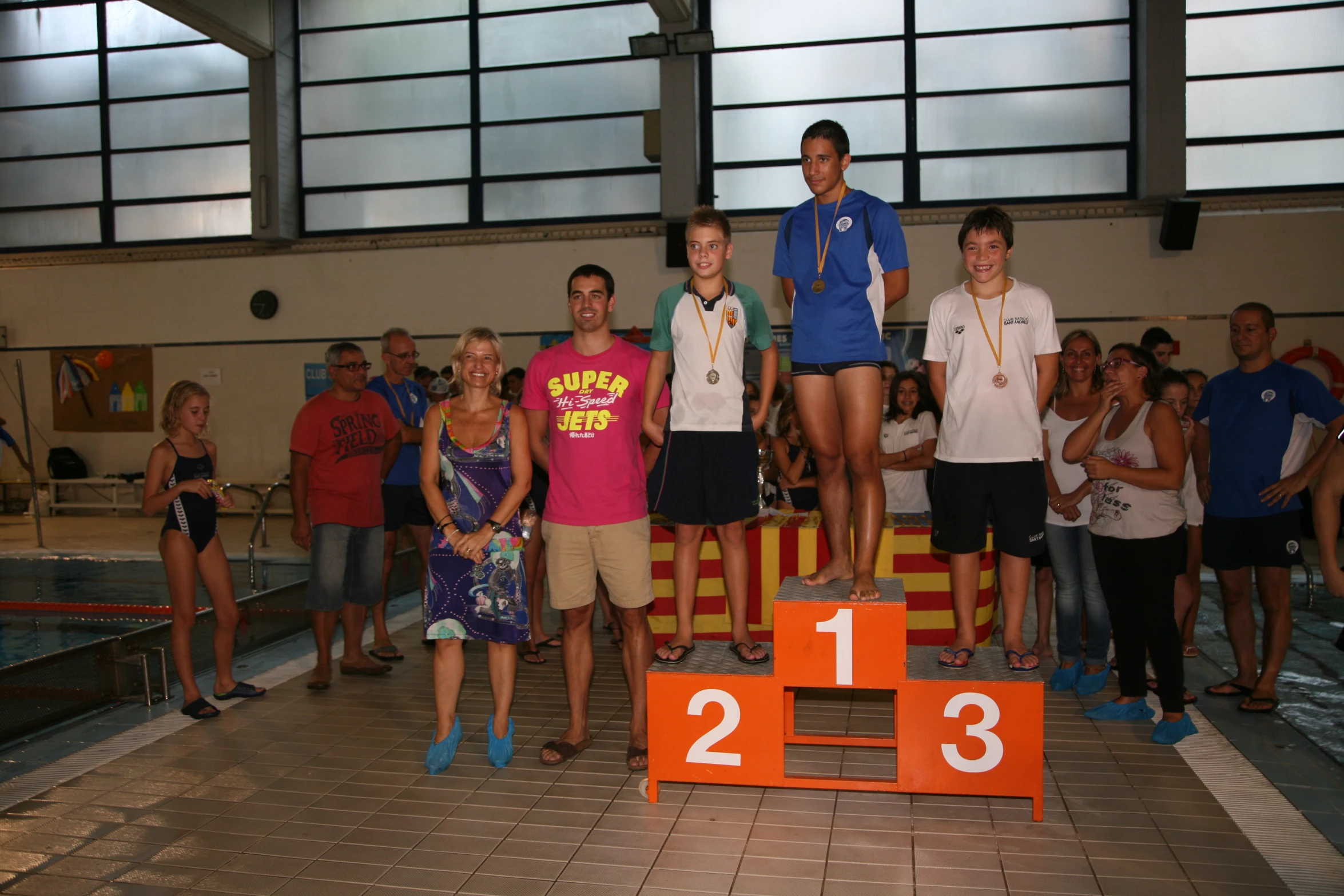 people watching boys and girls on a diving competition