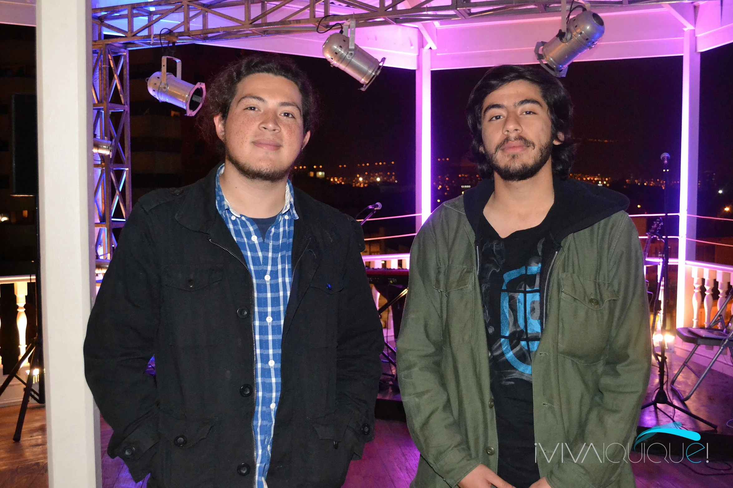 two young men looking at the camera with lights on