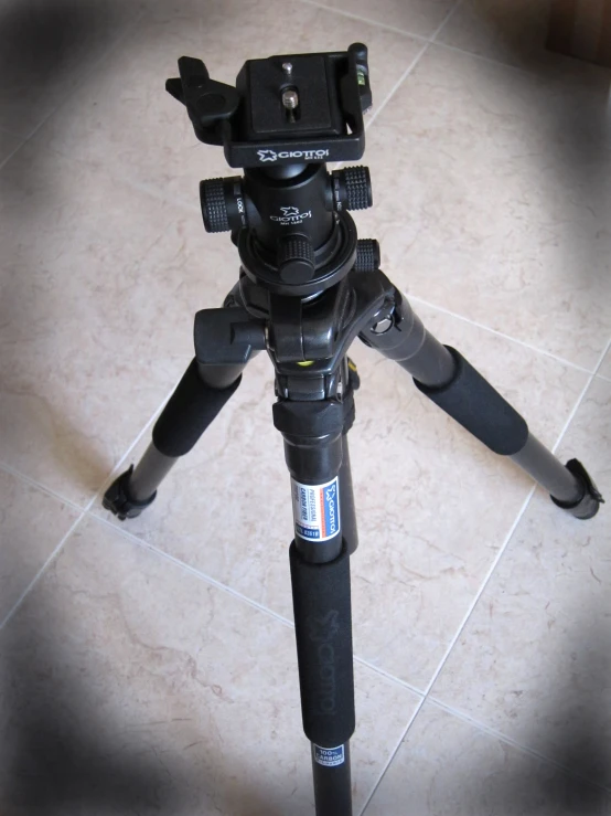 a tripod sits on top of a tile floor