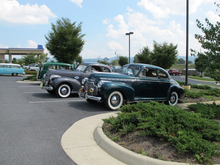 a couple of old vintage cars in a lot