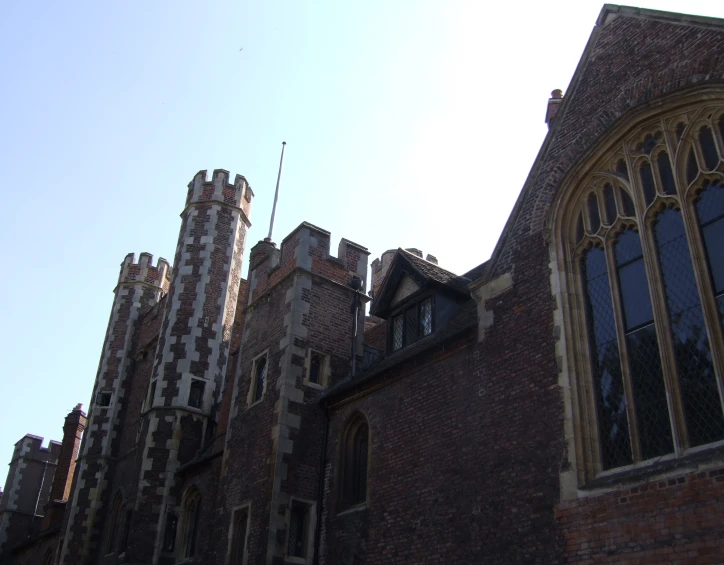 a tower of a large building with two stained glass windows