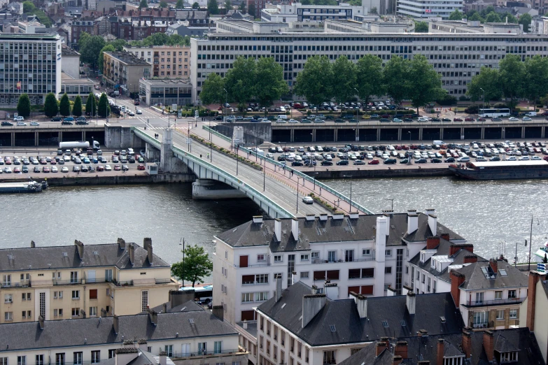 some boats and buildings near a bridge over the water