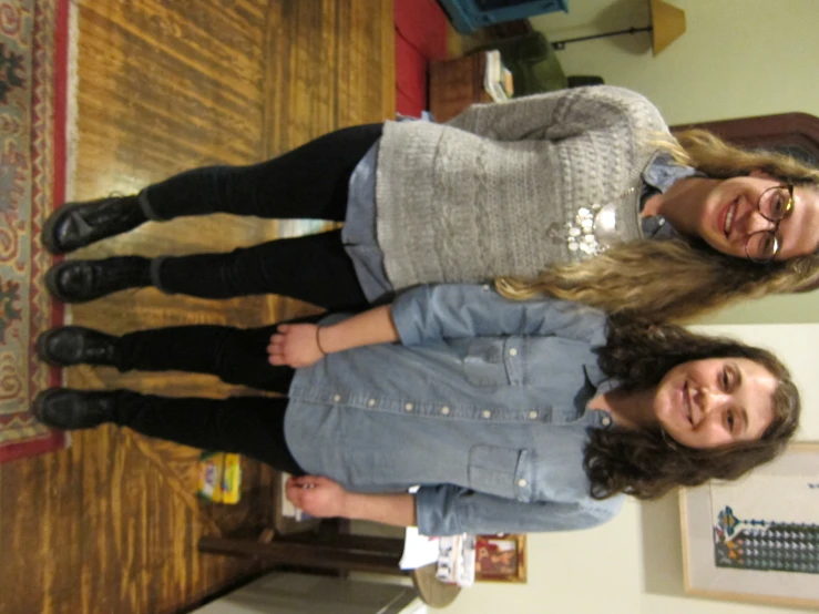 two girls stand in the hallway and pose for a po