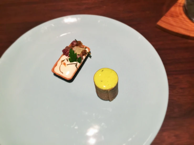 small food items sitting on the side of a plate