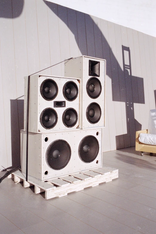 speakers are stacked up next to a wall