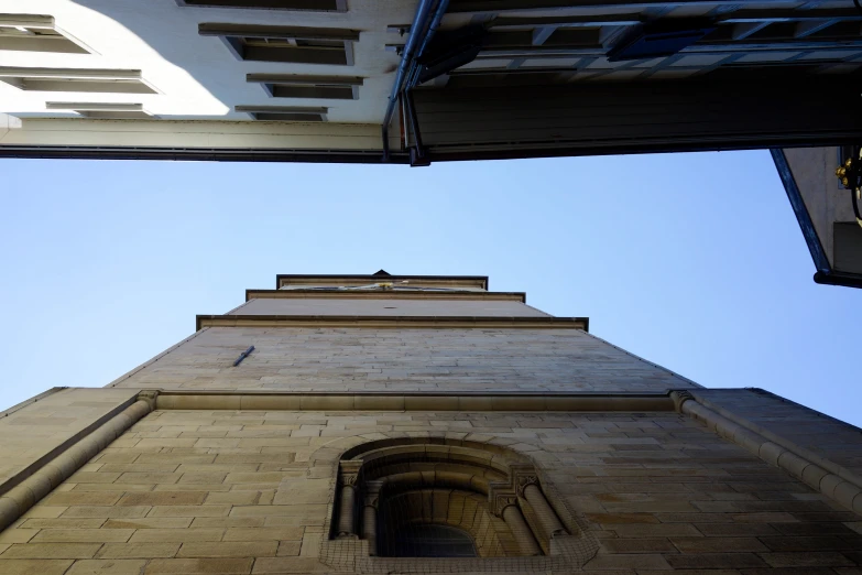 the view up at a tall, stone clock tower