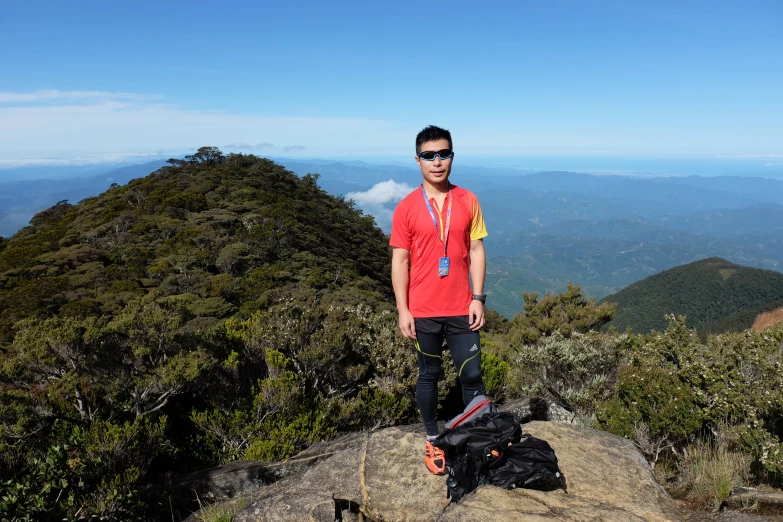 the man standing on top of a mountain