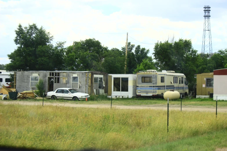 cars and motor home trailers parked in the lot