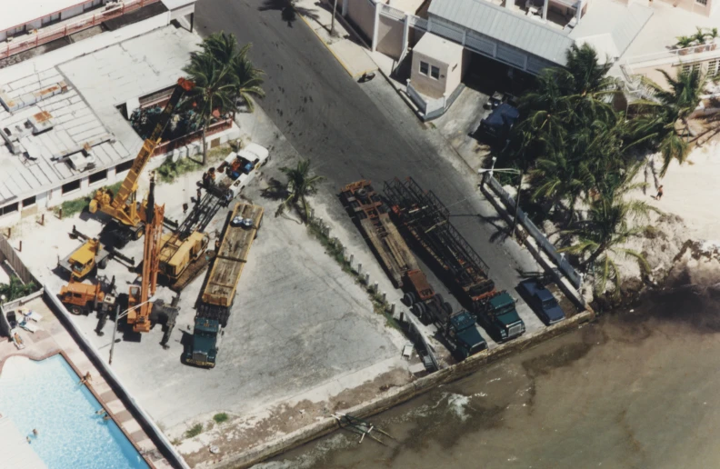 a crane, truck and crane attachments and trucks in an area by the water