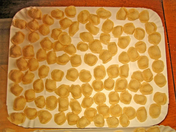 a white paper plate with pancakes cut into squares