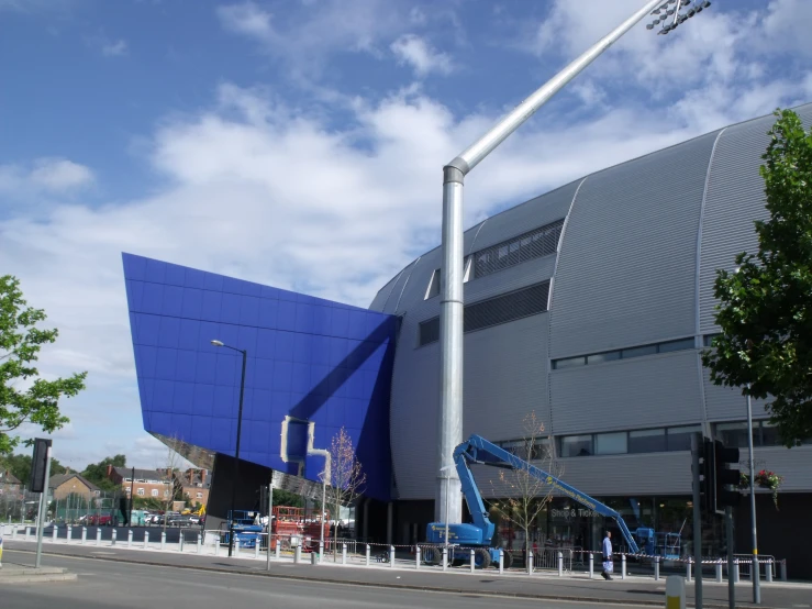 a blue building has a large flag on it