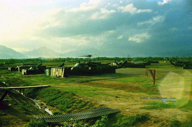 a bunch of tanks are parked outside in a field