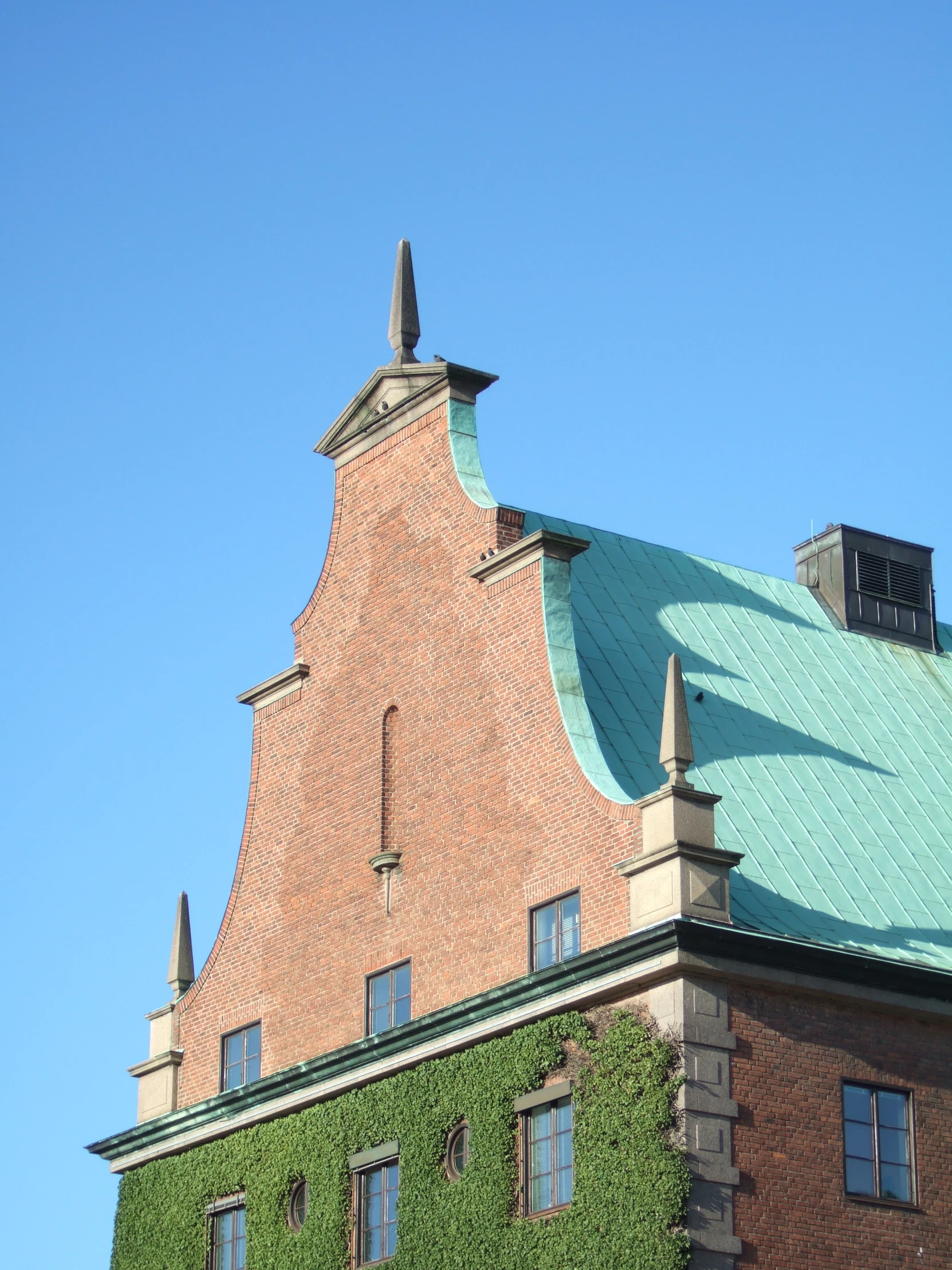 a very large building with many windows and a green roof