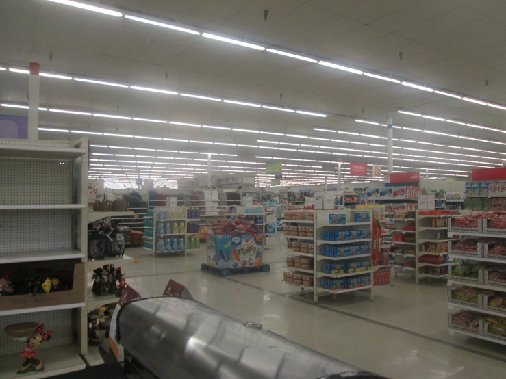 an empty grocery store with shelves filled with items