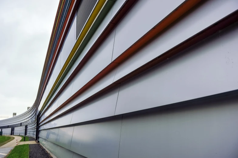 colorful lines against a white wall along a highway