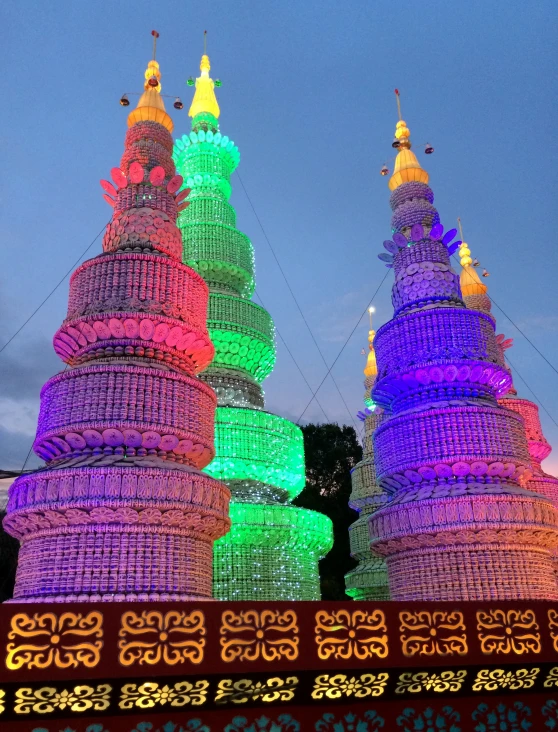 three lit up domes with trees and stars on them