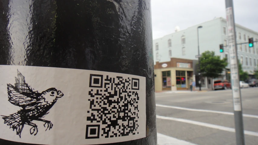 a picture of a sticker on a pole on a street