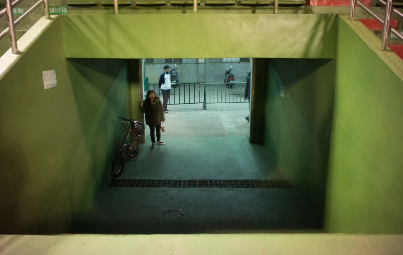 a couple of men standing in the middle of an alley