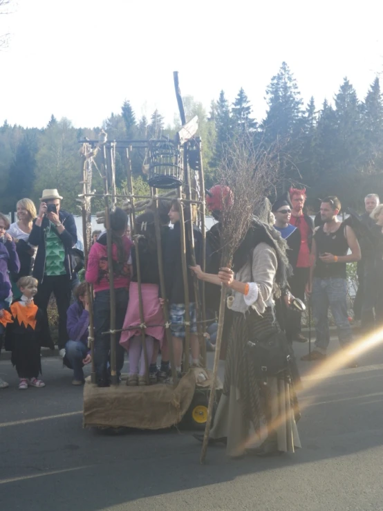 a man dressed in a costume standing next to an old fashioned ski lift