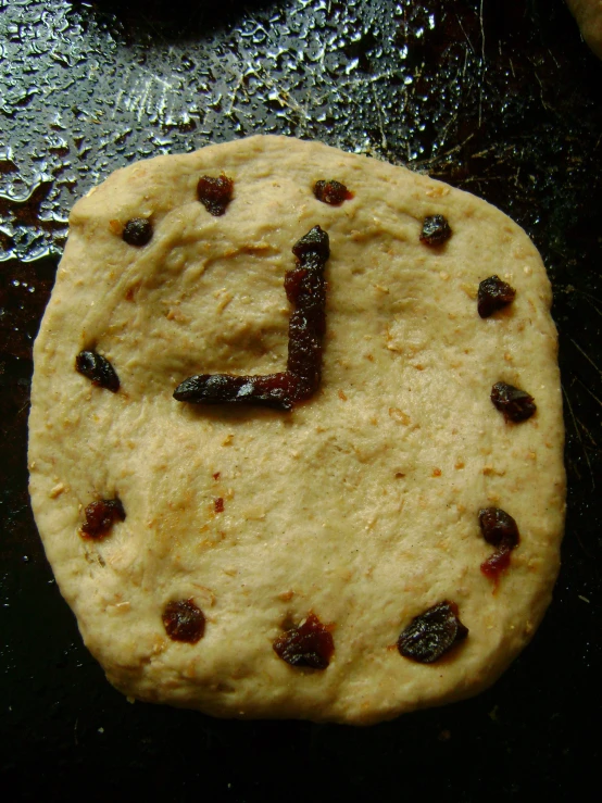 a cookie with a letter on it is shown in the middle of the frame