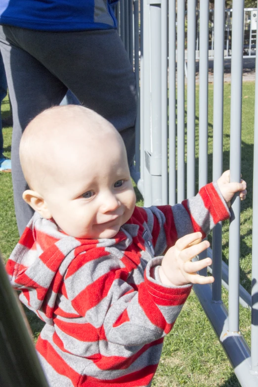 young child on play ground near metal posts