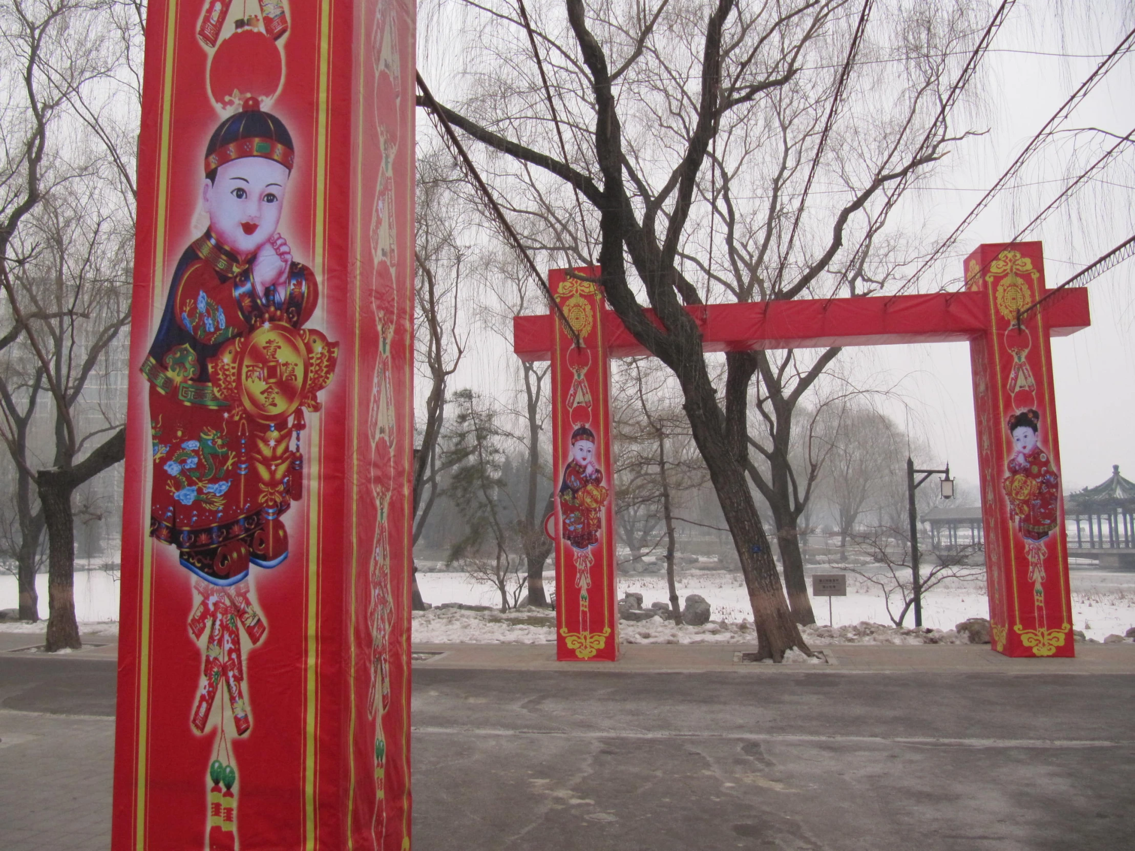 red lanterns decorated with buddha figure and flowers in snow