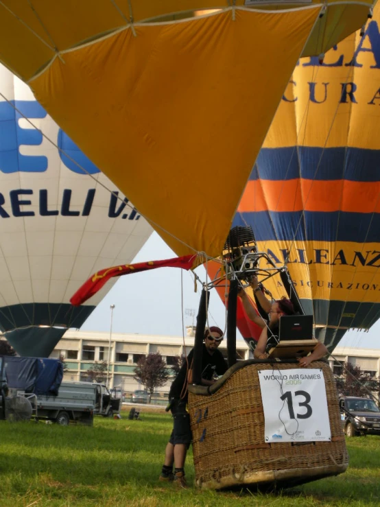 two people putting in the balloons for a flying competition