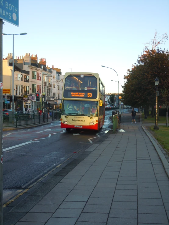 a double decker bus makes a turn on a street